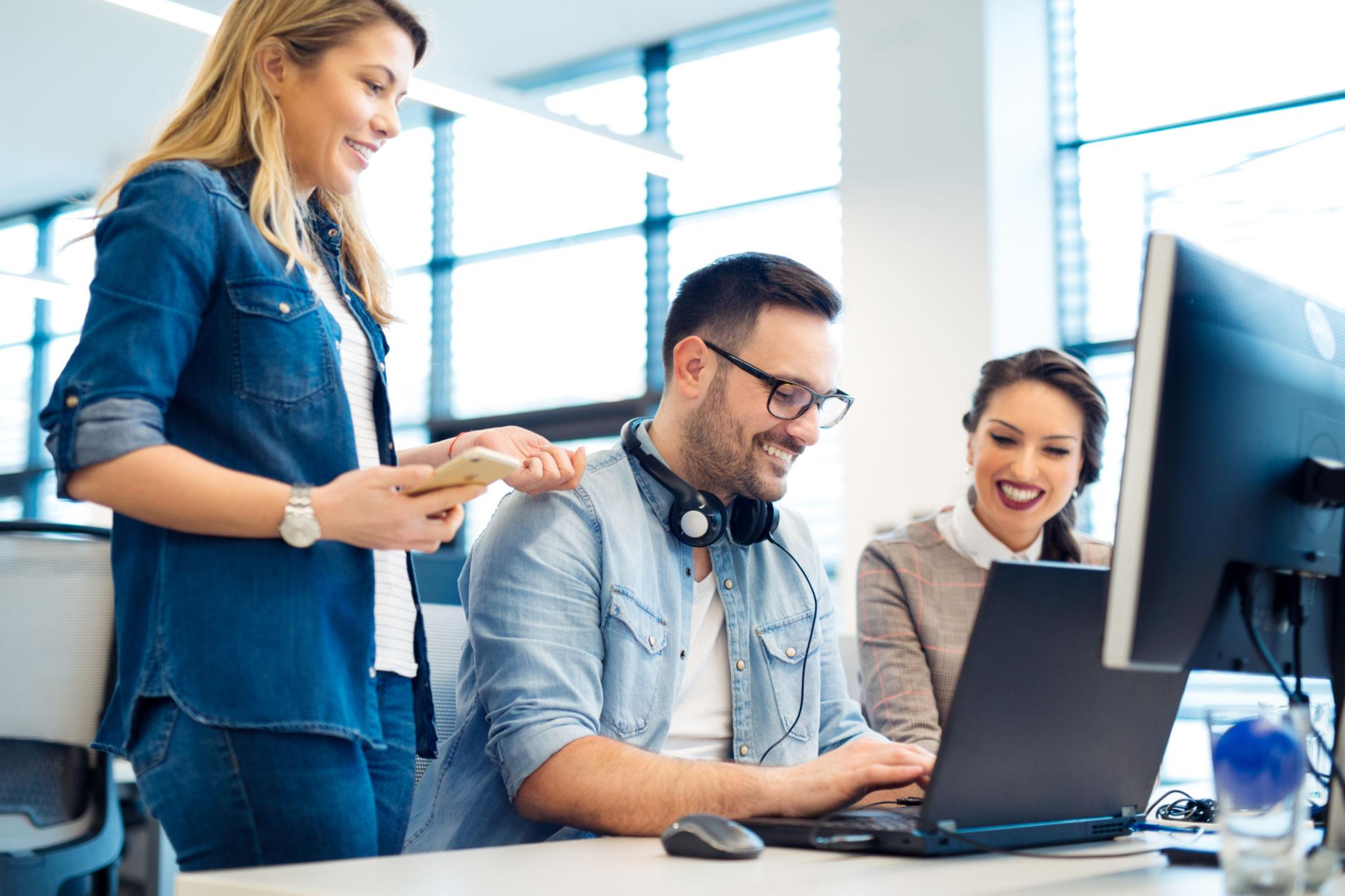 Team of employees collaborating together in a modern office
